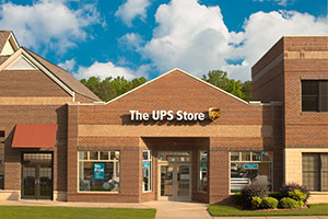Storefront of a UPS Store location during the day